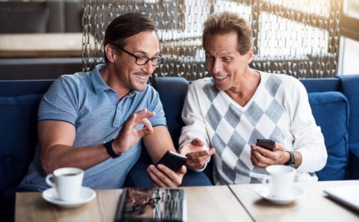 Two Happy Men Looking at Phones