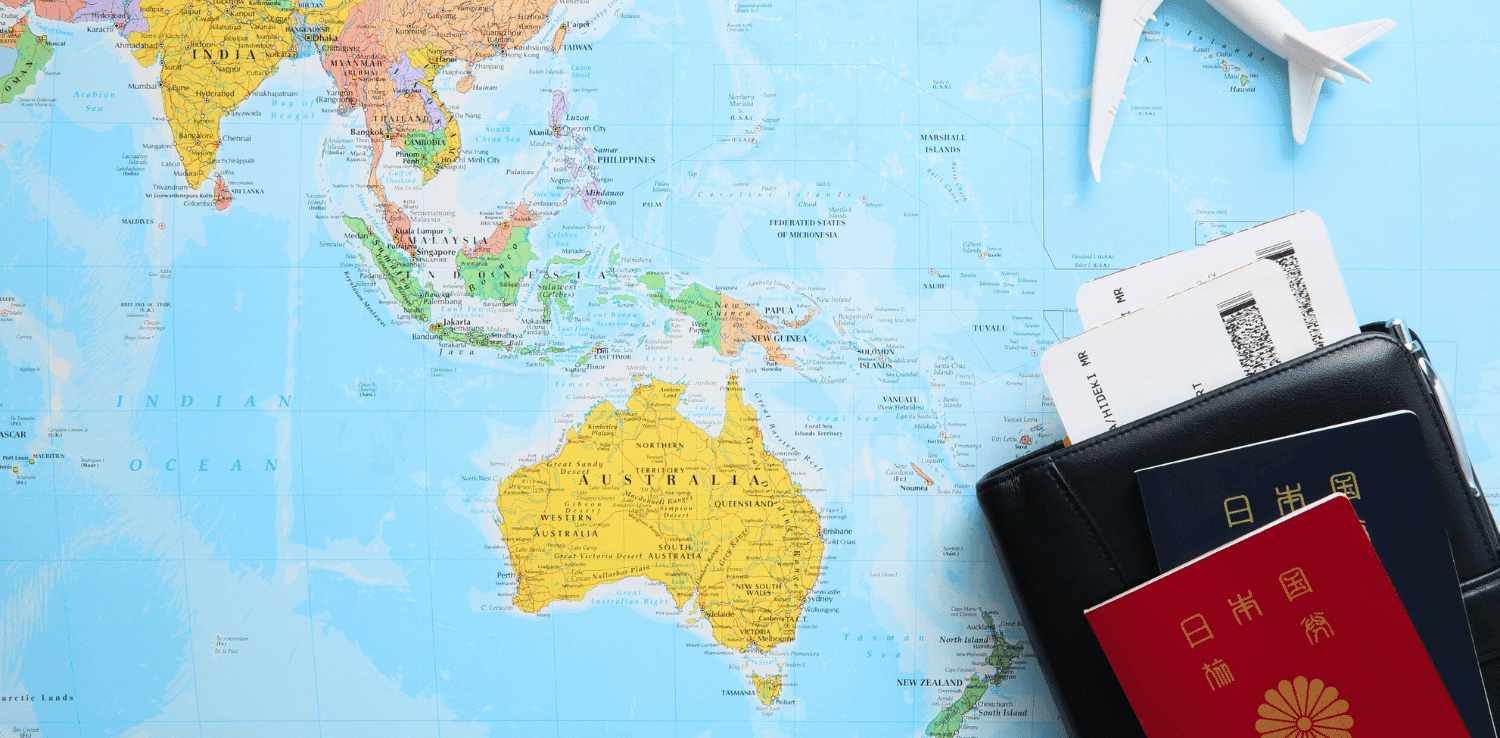 Passport, wallet and topy plane resting atop a map of the eastern hemisphere 